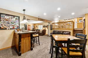 Dining space with light carpet and recessed lighting