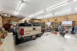 Garage featuring a heating unit and a workshop area