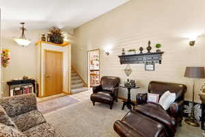 Sitting room with stairway, tile patterned floors, and carpet
