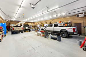 Garage featuring a workshop area and a garage door opener