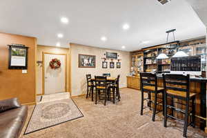 Carpeted dining area featuring a textured ceiling and recessed lighting