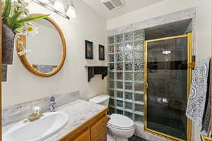 Full bathroom featuring vanity and a shower stall