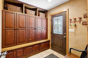 Mudroom with light tile patterned flooring