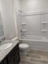Full bathroom featuring shower / washtub combination, light wood-style floors, and vanity