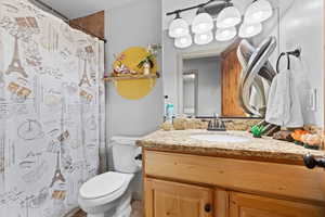 Full bath featuring vanity and curtained shower