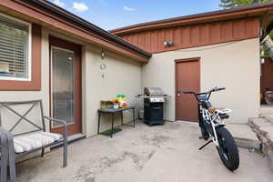 View of patio featuring a grill