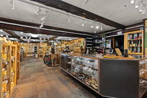 Misc room featuring beam ceiling, carpet, and track lighting