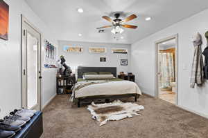 Bedroom with carpet floors, recessed lighting, ensuite bathroom, and a ceiling fan