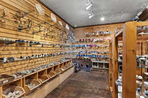 Wine area with wooden walls, a textured ceiling, and carpet