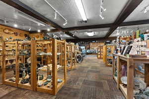Misc room featuring beamed ceiling, rail lighting, carpet, and a textured ceiling
