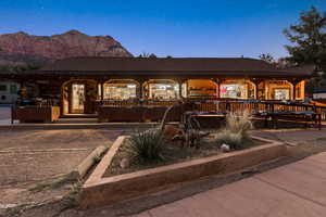 View of front of property featuring covered porch, roof with shingles, and a mountain view