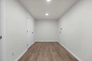 Empty room with wood finished floors and recessed lighting