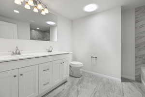 Full bathroom featuring double vanity, marble finish flooring, a bath, and a shower