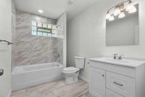 Full bath featuring vanity,  shower combination, and marble finish floors