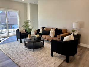 Living room featuring wood finished floors and recessed lighting