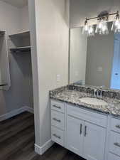 Bathroom with vanity and dark wood-style flooring