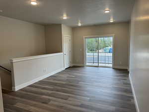 Unfurnished room featuring a textured ceiling, wood finished floors, and recessed lighting