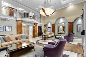 Building lobby with crown molding, a towering ceiling, and recessed lighting