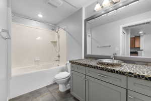 Full bathroom featuring recessed lighting,  shower combination, and vanity