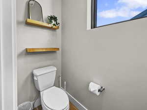 Bathroom with toilet and baseboards