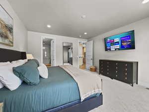 Carpeted bedroom featuring recessed lighting and ensuite bathroom
