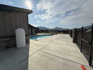 Community pool with a mountain view and a patio