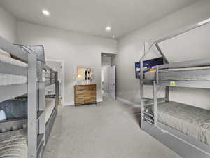 Carpeted bedroom with baseboards and recessed lighting