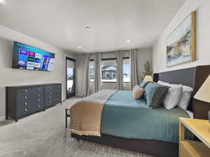 Bedroom with light colored carpet, recessed lighting, and access to outside