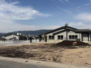 View of property exterior featuring board and batten siding, stone siding, and a mountain view