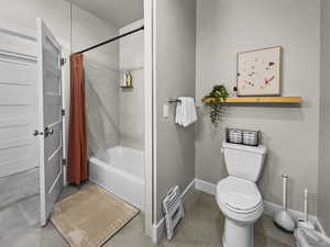 Full bath featuring shower / bathtub combination with curtain and toilet