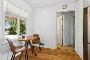 Dining space with light wood-type flooring and baseboards