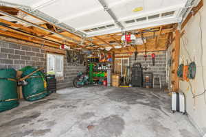 Garage with a garage door opener and concrete block wall