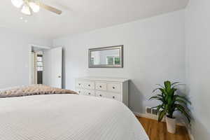 Bedroom featuring wood finished floors and a ceiling fan