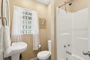 Bathroom featuring toilet and shower / tub combination