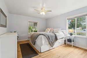 Bedroom featuring multiple windows and light wood-style flooring