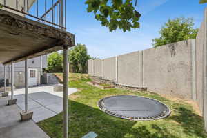 Fenced backyard with a patio area