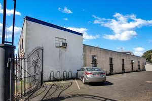 View of property featuring uncovered parking