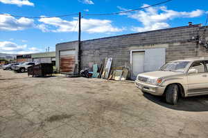 View of outbuilding with uncovered parking