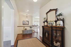 Hallway with dark wood finished floors and recessed lighting