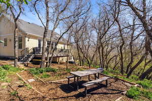 View of yard with a wooden deck