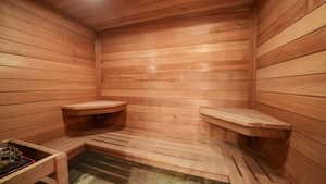 Relaxing sauna featuring wood walls and wood ceiling