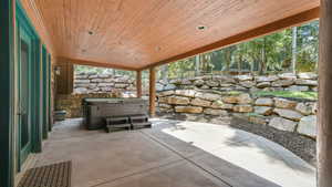 View of patio with a hot tub