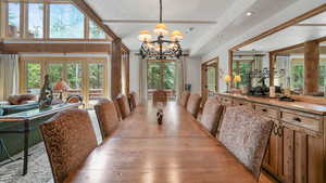 Dining room with a chandelier, healthy amount of natural light, a textured ceiling, recessed lighting, and wood finished floors