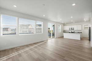 Unfurnished living room with recessed lighting and light wood-style flooring
