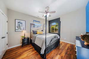 Bedroom with wood finished floors, ceiling fan, and a closet