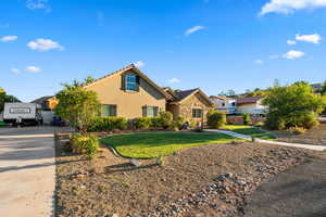 Traditional-style home with stucco siding, concrete driveway, stone siding, and a tiled roof