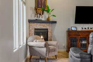Sitting room with baseboards and a fireplace