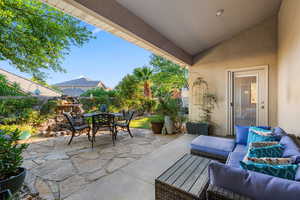 Fenced backyard featuring a patio, an outdoor hangout area, and outdoor dining space