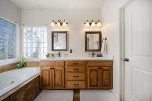 Bathroom with double vanity and a whirlpool tub