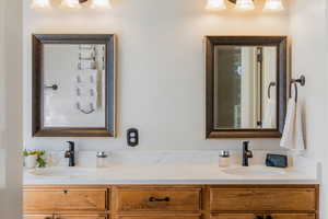 Full bath featuring double vanity